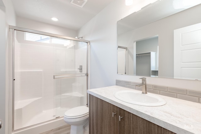 4435 N Magical Creek Ave, Meridian, ID 83646 - bathroom featuring a stall shower, toilet, decorative backsplash, and visible vents
