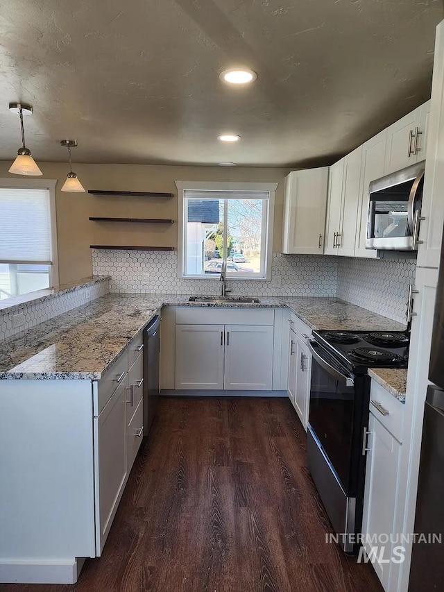 108 Morrison, Caldwell, ID 83605 - kitchen with appliances with stainless steel finishes, dark wood finished floors, backsplash, light stone counters, and recessed lighting