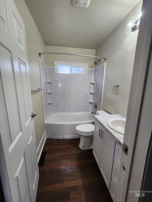 108 Morrison, Caldwell, ID 83605 - full bath with wood finished floors, bathing tub / shower combination, vanity, a textured ceiling, and a textured wall