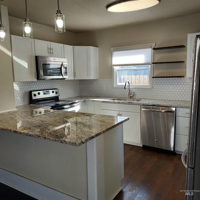 108 Morrison, Caldwell, ID 83605 - kitchen featuring stainless steel appliances, white cabinetry, dark wood-style flooring, and light stone counters