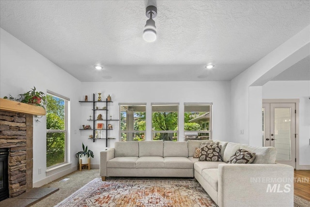 6370 E Escarpment Ct, Boise, ID 83716 - living area featuring a fireplace, a textured ceiling, recessed lighting, baseboards, and french doors
