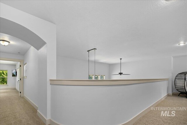 6370 E Escarpment Ct, Boise, ID 83716 - corridor with carpet flooring, a textured ceiling, baseboards, and arched walkways