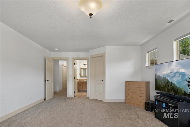 6370 E Escarpment Ct, Boise, ID 83716 - bedroom featuring light colored carpet, a textured ceiling, ensuite bathroom, and baseboards