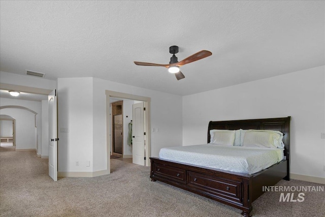 6370 E Escarpment Ct, Boise, ID 83716 - bedroom with light colored carpet, arched walkways, a ceiling fan, and baseboards