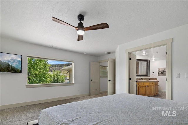 6370 E Escarpment Ct, Boise, ID 83716 - carpeted bedroom with a textured ceiling, ensuite bath, a ceiling fan, and baseboards