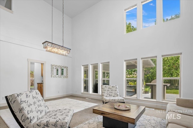 6370 E Escarpment Ct, Boise, ID 83716 - living area featuring a towering ceiling, healthy amount of natural light, a chandelier, and carpet