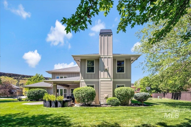 6370 E Escarpment Ct, Boise, ID 83716 - back of house featuring board and batten siding and a chimney