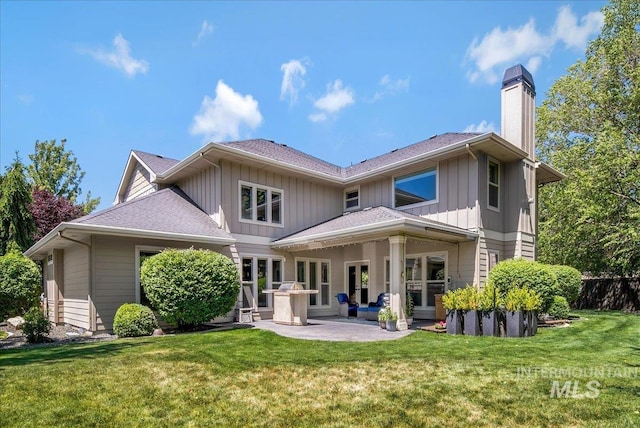 6370 E Escarpment Ct, Boise, ID 83716 - back of house with a chimney, a patio area, board and batten siding, and a lawn