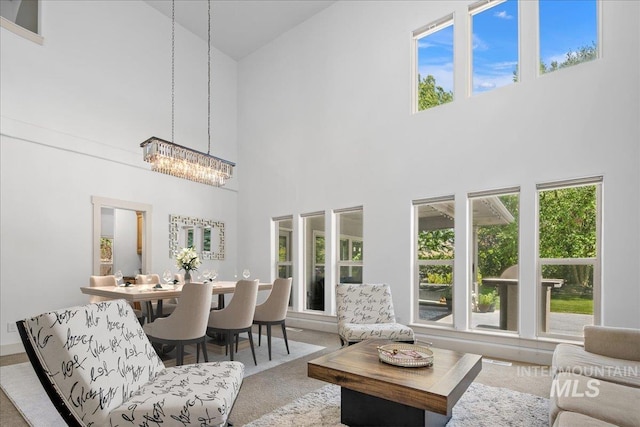 6370 E Escarpment Ct, Boise, ID 83716 - living area with a towering ceiling, healthy amount of natural light, a chandelier, and carpet
