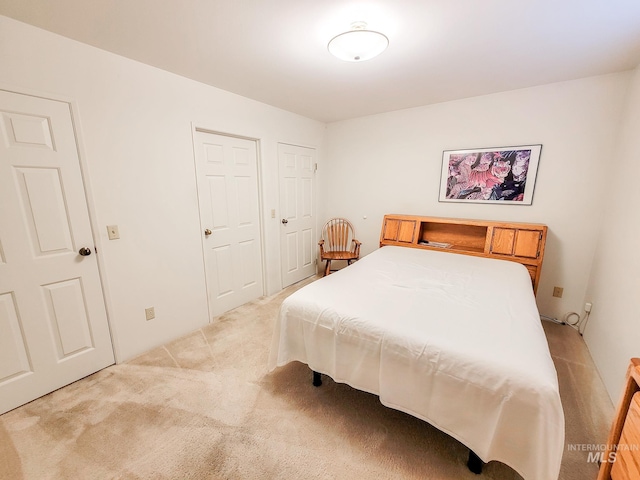 bedroom with light colored carpet