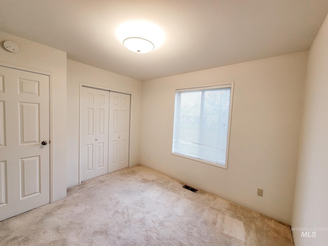 unfurnished bedroom featuring a closet and carpet floors