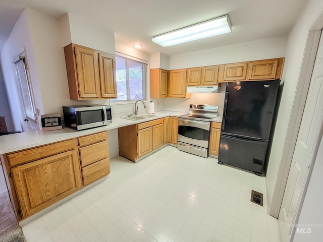 kitchen with under cabinet range hood, stainless steel appliances, light countertops, and a sink