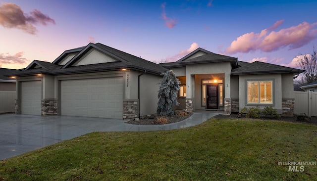 view of front of house featuring a garage and a yard