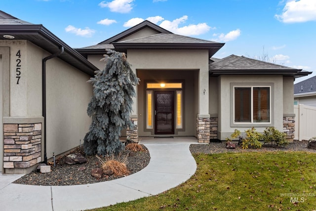 entrance to property featuring a lawn