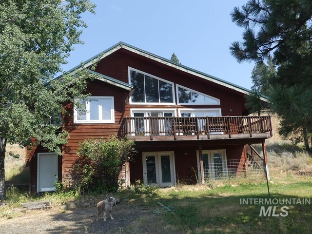 back of house with a wooden deck