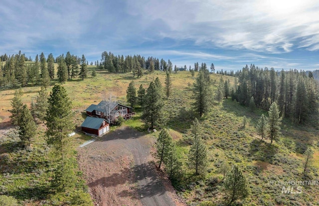 birds eye view of property with a wooded view