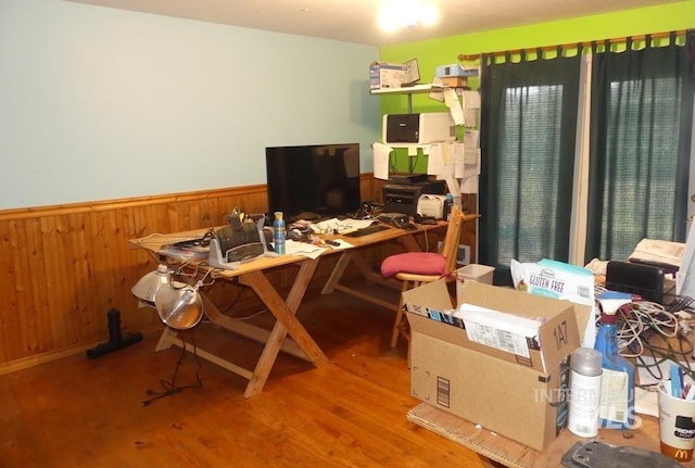 office with a wainscoted wall, wood finished floors, and wooden walls