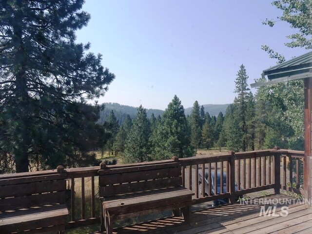 wooden deck with a forest view