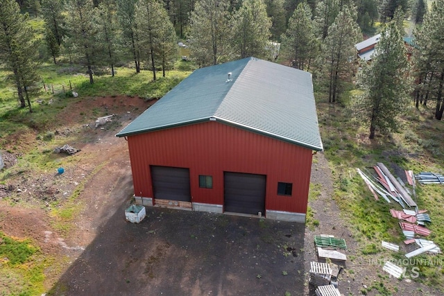 view of outbuilding with an outbuilding and a forest view