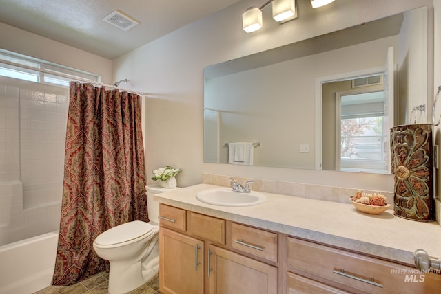 full bathroom featuring vanity, toilet, visible vents, and shower / tub combo with curtain