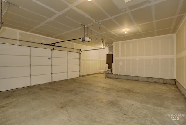 garage featuring electric panel and a garage door opener