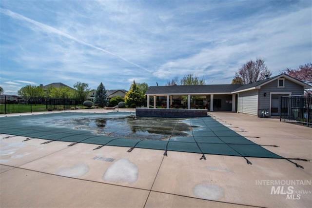 pool featuring a patio and fence