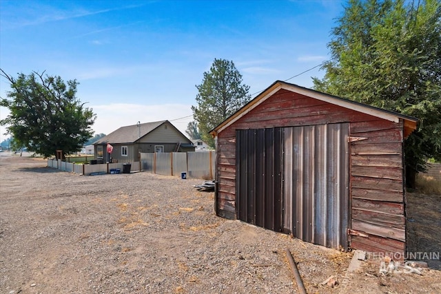 view of shed with fence