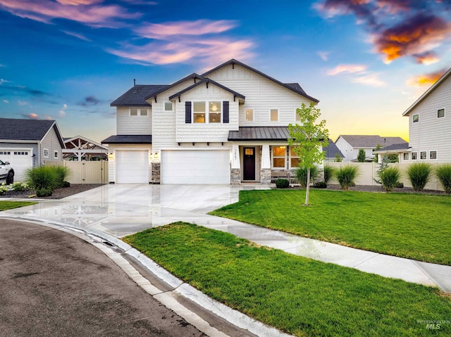 view of front of property featuring a garage and a lawn