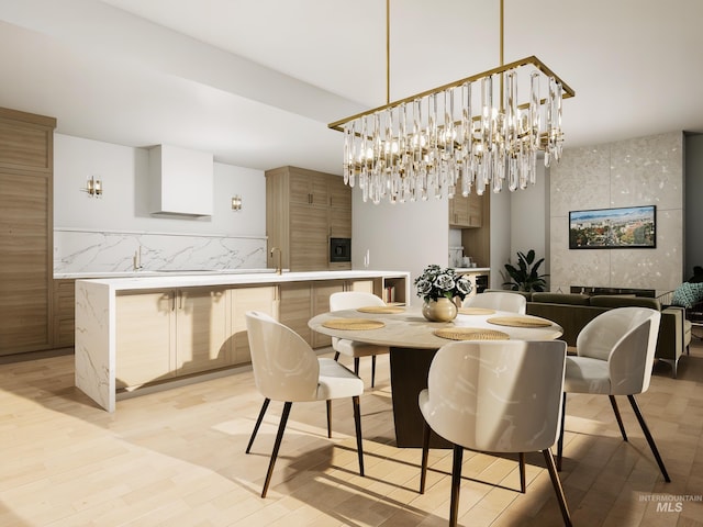 dining area featuring light wood-type flooring and an inviting chandelier