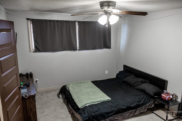 bedroom with light carpet, a textured ceiling, and ceiling fan