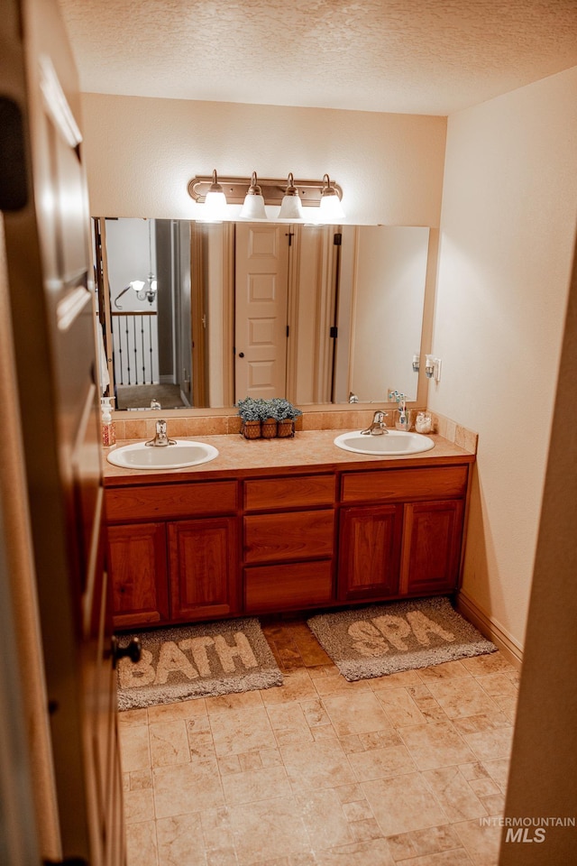 bathroom featuring vanity and a textured ceiling