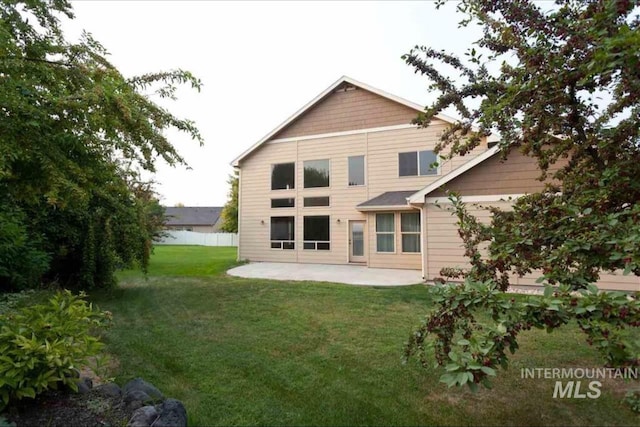 rear view of property with a patio area and a yard