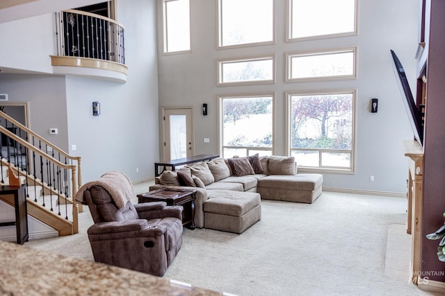 carpeted living room with a high ceiling