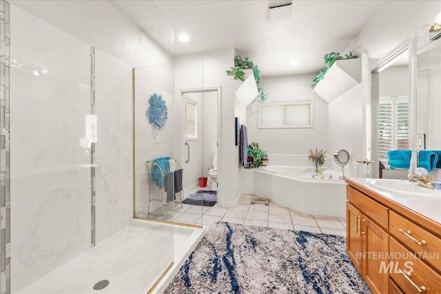 bathroom with a bath, tile patterned flooring, a shower stall, vanity, and toilet