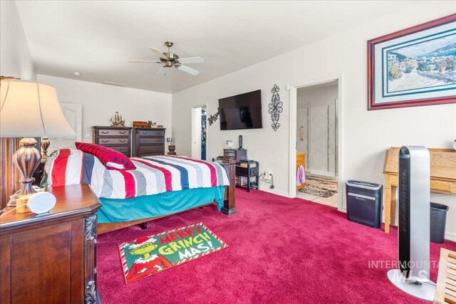 bedroom with baseboards, a ceiling fan, carpet flooring, and ensuite bath