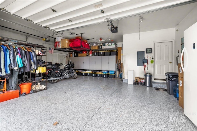 garage featuring a garage door opener and electric panel