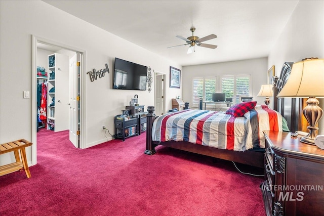 carpeted bedroom with baseboards, a ceiling fan, and a spacious closet
