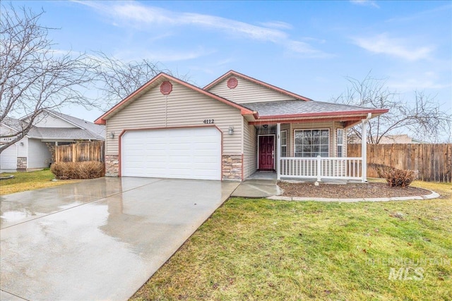 view of front of house featuring an attached garage, covered porch, fence, concrete driveway, and a front lawn