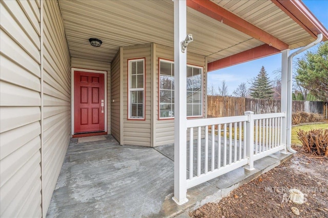 entrance to property featuring fence