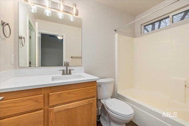 full bath featuring washtub / shower combination, vanity, and toilet