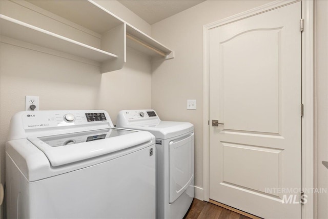 washroom with laundry area, separate washer and dryer, and dark wood finished floors