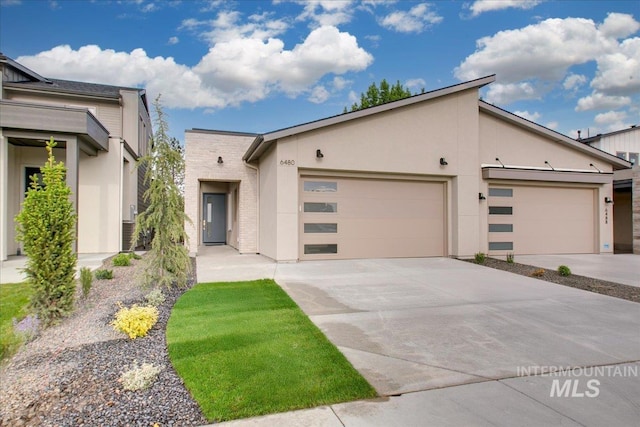 6480 S Astoria Ave, Meridian, ID 83642 - view of front of home with an attached garage, concrete driveway, and stucco siding