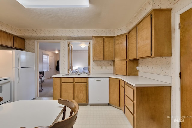 kitchen featuring white appliances and sink