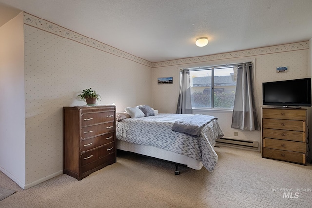 bedroom featuring light carpet, a baseboard radiator, and a textured ceiling