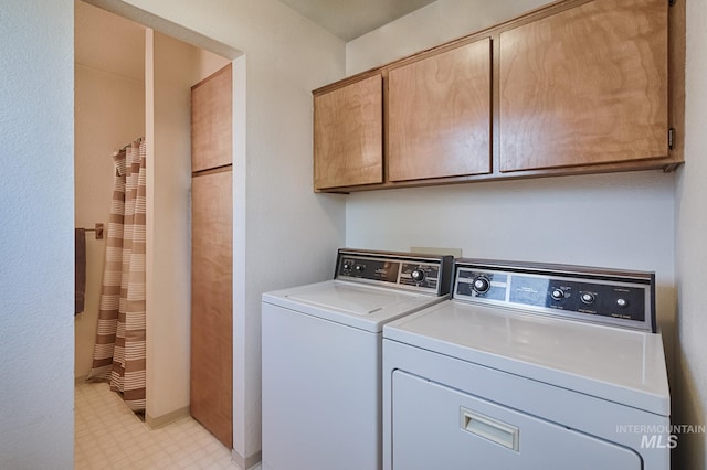 washroom with cabinets and separate washer and dryer