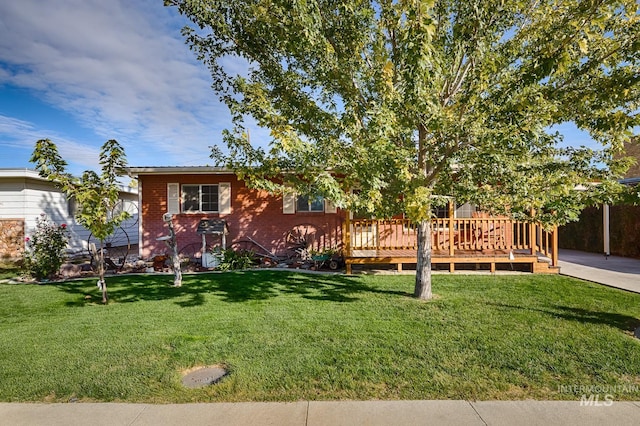 exterior space with a wooden deck and a front lawn