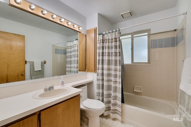 full bathroom with vanity, toilet, shower / tub combo, and a textured ceiling