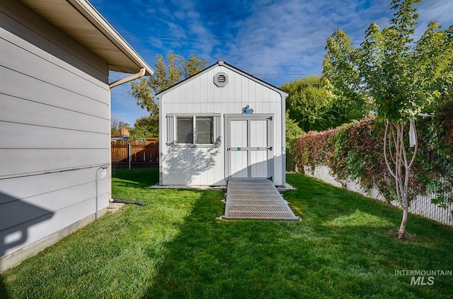 view of outbuilding featuring a yard