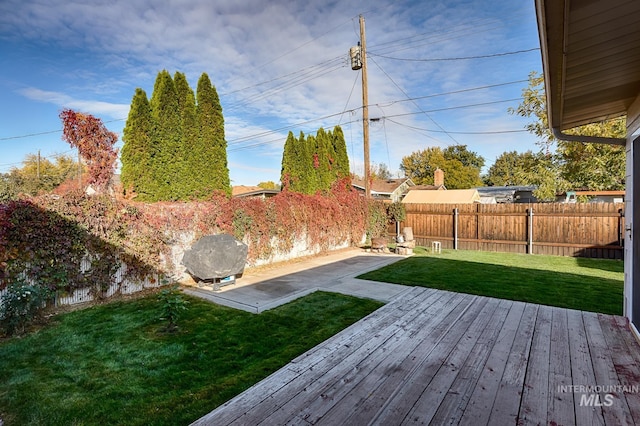 view of yard featuring a wooden deck and a patio area