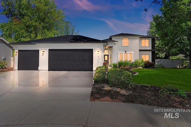 5915 N Lilybrook Pl, Boise, ID 83713 - view of front of house with stucco siding, a garage, and driveway